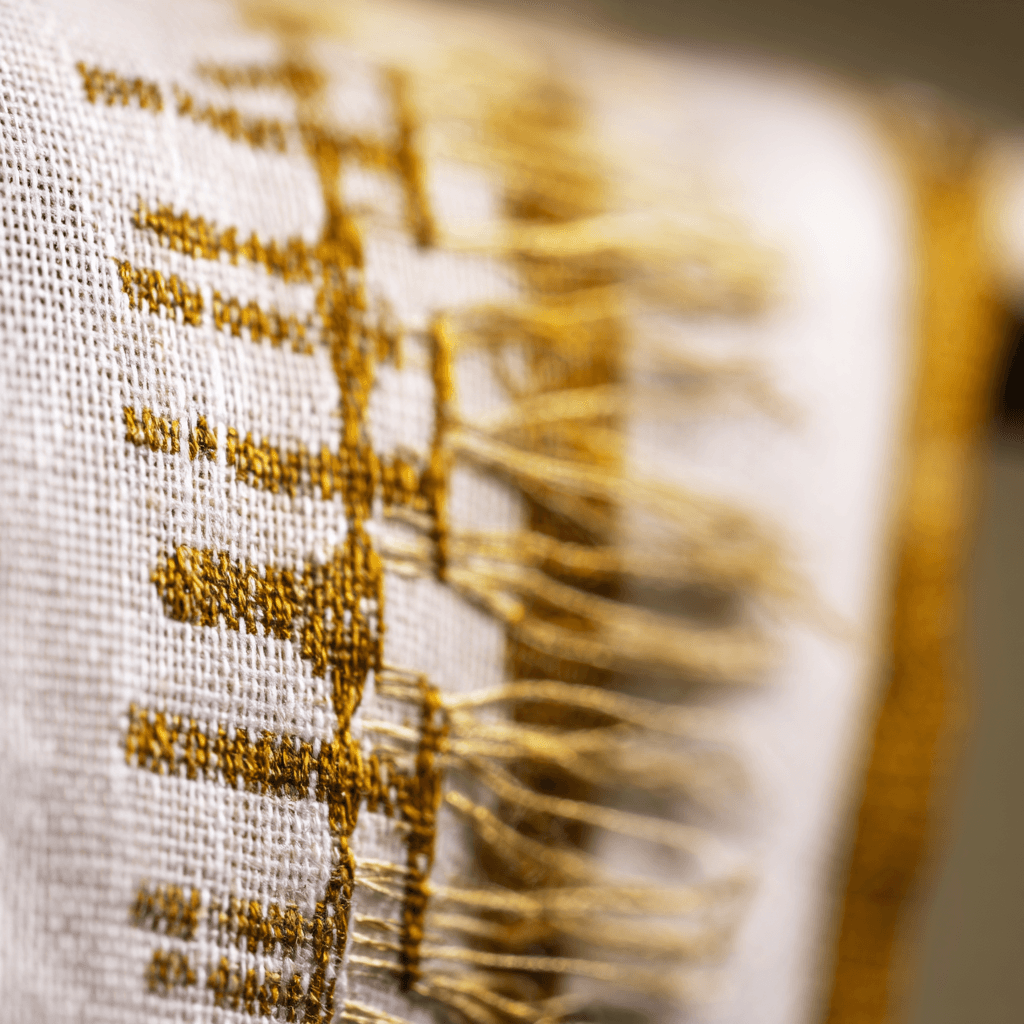 Close-up of Ethiopian hand-woven tibeb border in gold thread